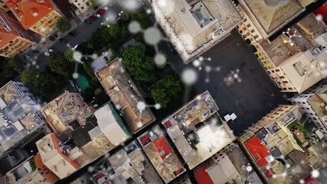 animation of connections moving over aerial view of modern city buildings