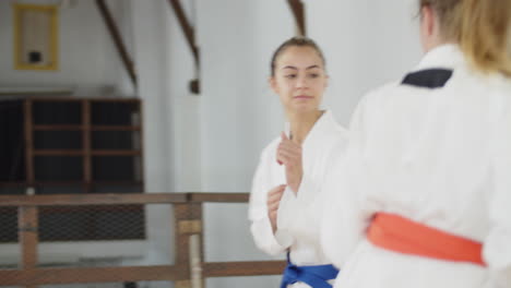 handheld shot of martial artists greeting each other in bow