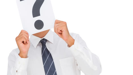 caucasian businessman holding question mark sign over face