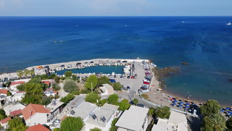 aerial rising shot in front of the faliraki harbor, sunny day in rhodes, greece