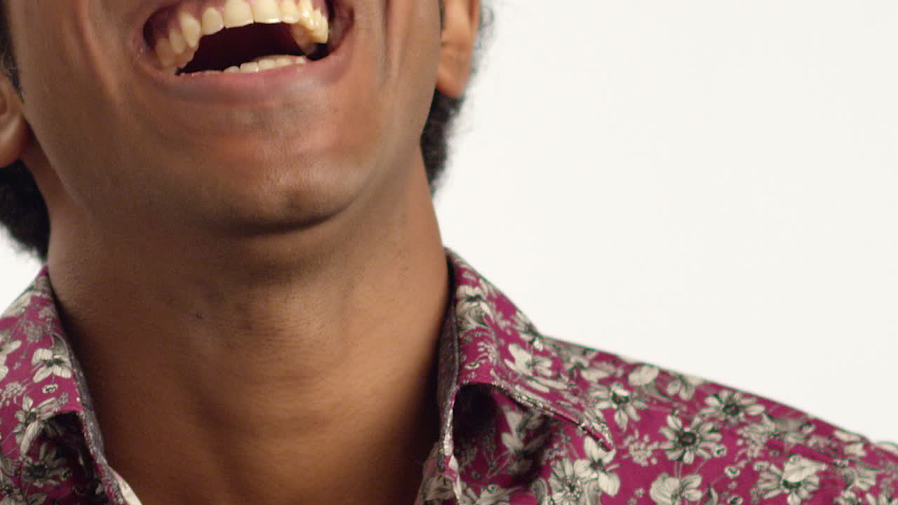 ECU Young Man Laughs at Camera