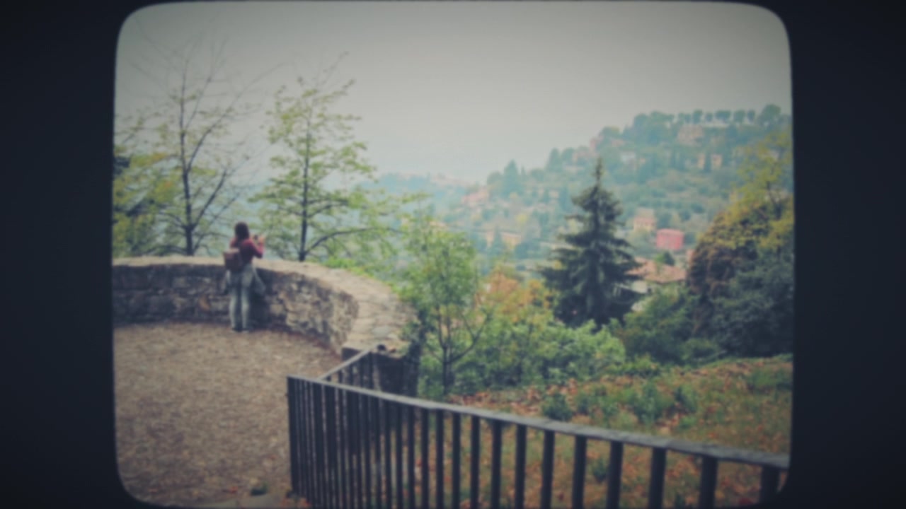 Young woman takes photos of old town