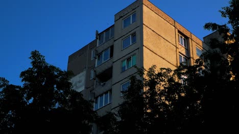 old soviet russia style block building like in chernobyl tv series with hand held shot looks like real person looking to it