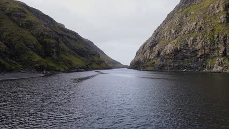 Drone-footage-following-the-inlet-near-the-black-sand-beach-near-the-Saksun-village-on-the-Streymoy-island-in-the-Faroe-Islands