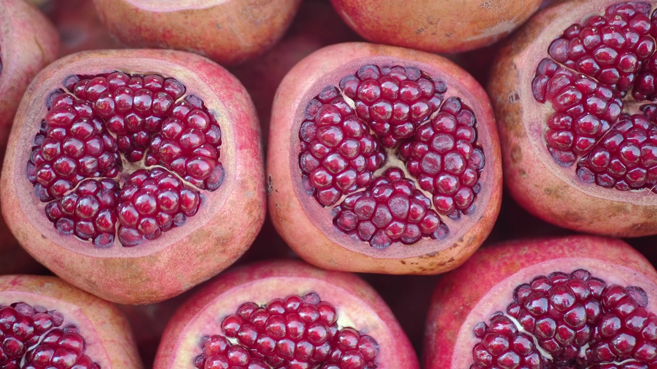 Close-up Overhead View of Fresh Pomegranates Cut in Half