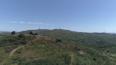 vista aérea de la casa en las montañas con molinos de viento