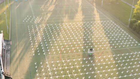 rows of empty chair on playing field for commencement ceremony of students during pandemic