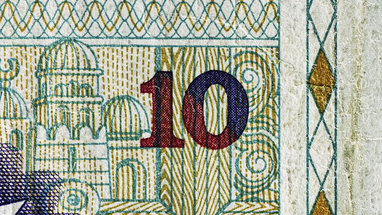 Stop-motion animation aligning the number ten across diverse paper currencies
