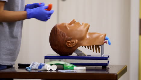 medical training on a mannequin head. specialist demonstrates reanimation procedure on a face dummy. close-up.
