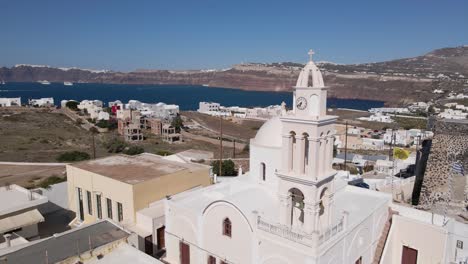 aerial close fly by greek church bell tower at akrotiri village in santorini, greece