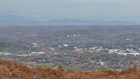 an aerial view above the mountains in upstate ny during the fall season on a beautiful day