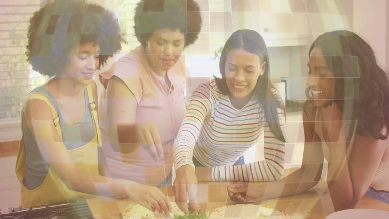 엄마가 부엌 아일랜드에서 허브를 가져와 반죽에 뿌리고, 여성들이 요리를 위해 토핑을 정리하고 있어요.