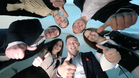 happy business team with thumbs up. successful business people with thumbs up and smiling