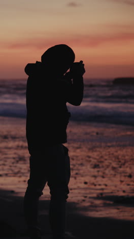 silhouette of a photographer at sunset beach