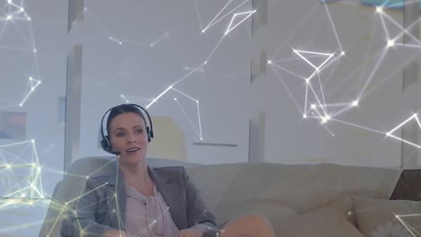 Animation-of-network-of-connections-over-businesswoman-with-headset-in-office