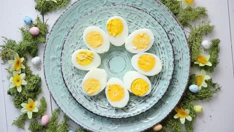 easter table setting with flowers and eggs  decorative plates with boiled eggs