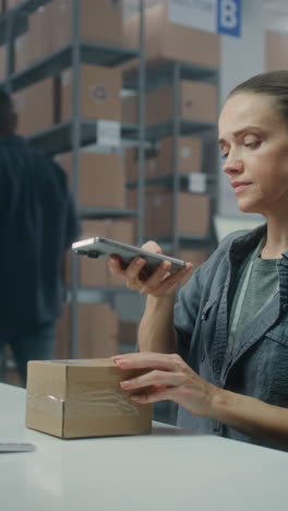 warehouse worker using smartphone for inventory