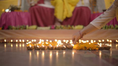 lighting diyas at home. celebrating indian festival.