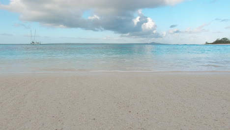 Pristine-calm-tropical-beach-with-yacht