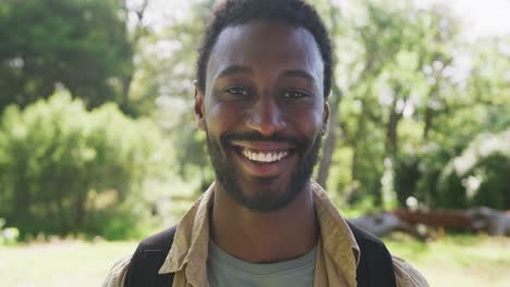 Portrait-of-happy-african-american-man-looking-at-camera-in-park,-slow-motion