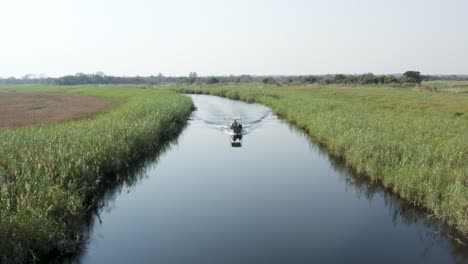 boat trip with tourists in the chobe national park, cuando river, caprivi strip, namibia, africa - aerial drone shot