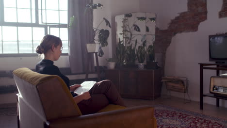 woman reading in a stylish retro living room