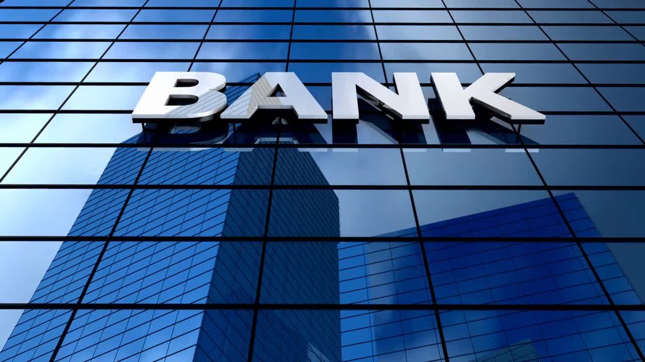 Modern bank building with reflective glass exterior in the city