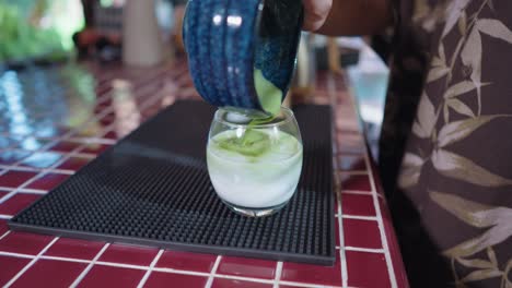 preparing an iced matcha latte
