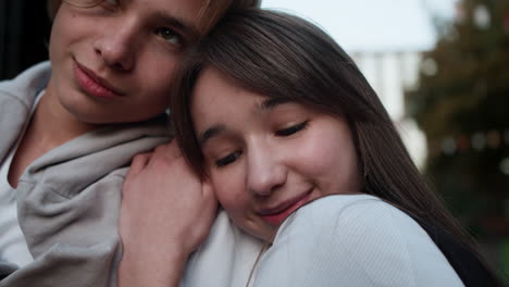 teenage boy and girl hugging