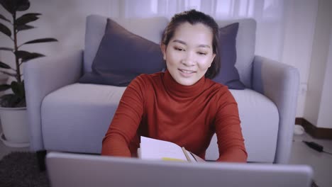 businesswoman on redshirt using the laptop for meeting online and work from home in coronavirus