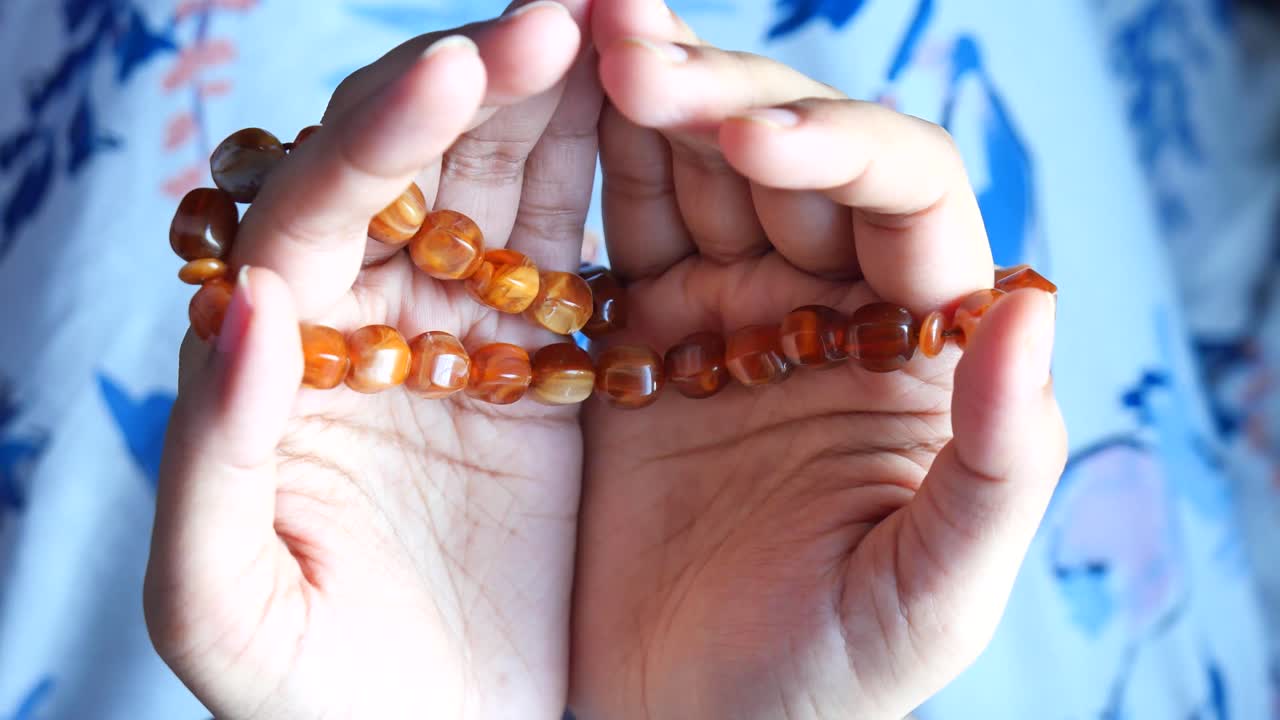 Hands Holding Prayer Beads
