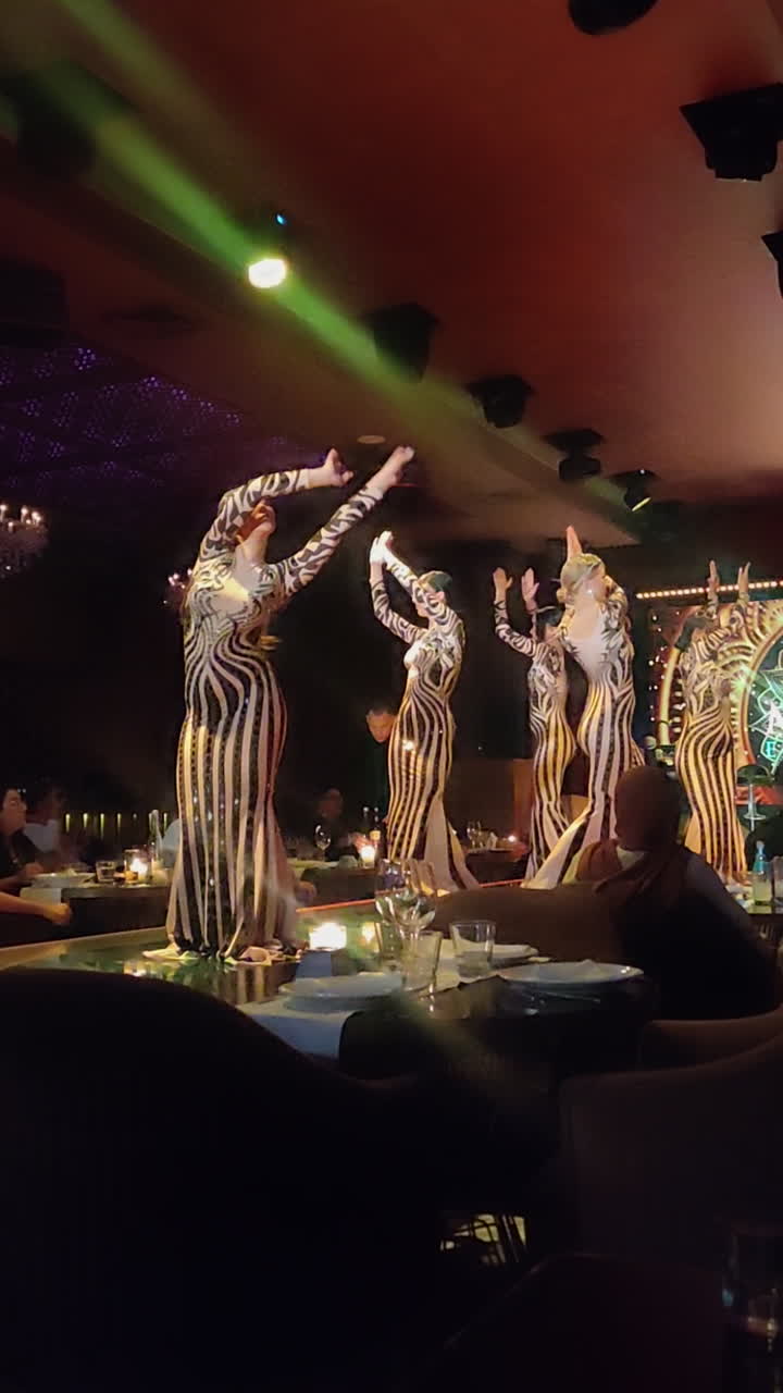 Dancers Performing On Stage At Luxury Restaurant Malak Emeraude In Marrakesh, Morocco. vertical shot