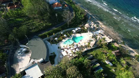 luxury pool club in nusa penida island, indonesia - aerial top down parallax