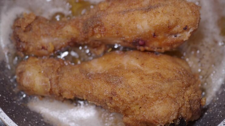 Crispy Fried Chicken Legs Cooking in Pan