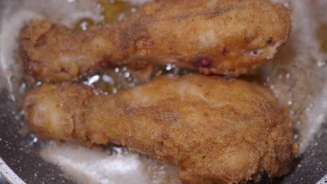 crispy fried chicken legs cooking in pan