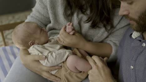 parents lovingly holding newborn baby