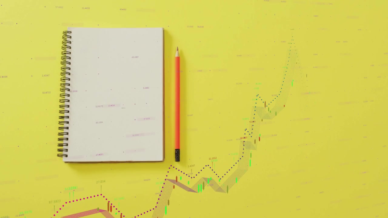 Spiral notebook and orange-black pencil dotted lines starting graph rising and falling on yellow