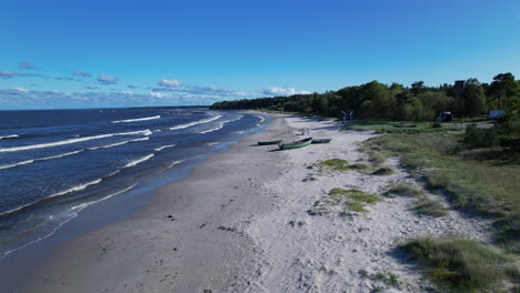 a sandy beach with a boat on the shore
