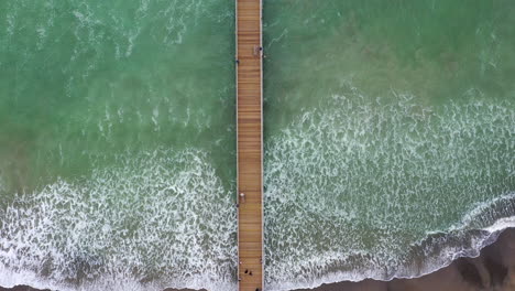 birds eye view drone shot of a californian jetty out at sea