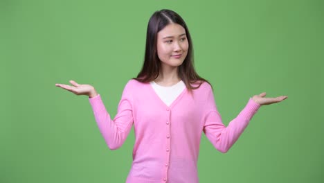 young beautiful asian woman choosing between left and right