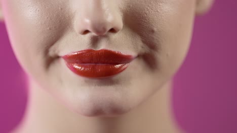 close-up of woman with red lipstick and lollipop