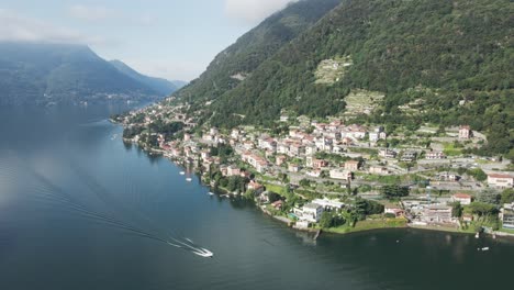 a boat passes a famous villa along lake como in italy