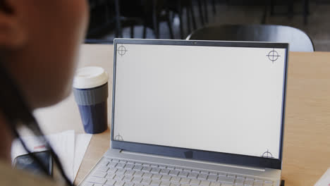 african american businesswoman talking during video call on laptop with copy space, slow motion