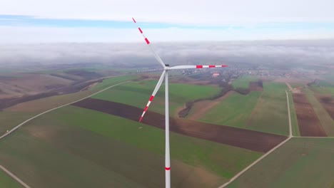 palas giratorias con rayas rojas de la turbina eólica por la mañana temprano