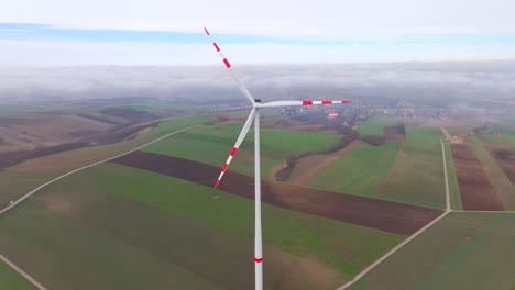 spinning blades with red stripes of wind turbine in the early morning