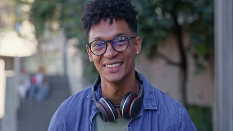 portrait of a student with headphones and glasses