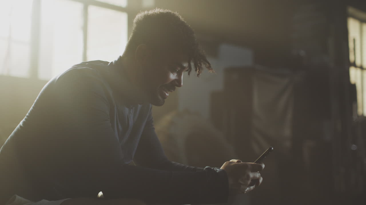 Man using smartphone in a workshop