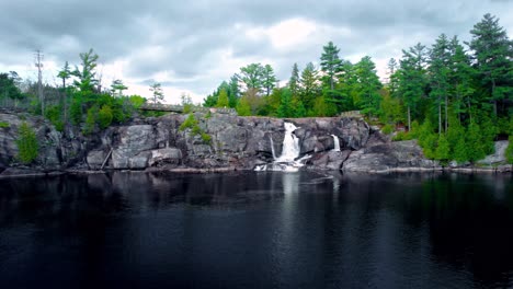 cascada rocosa que fluye y paisaje escénico del lago con mirador del acantilado high falls muskoka ontario