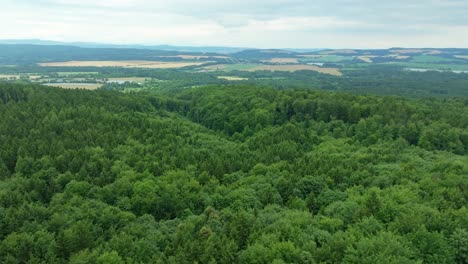 landscape of green forests from an aerial view. czech republic with diverse hilly nature, fields, meadows and villages in summer
