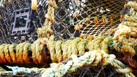 stacked empty fishing industry lobster net baskets dolly right closeup